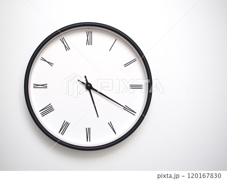 Clock Showing 17.20 or 05.20 with Roman Numerals. Simple Round Clock for Concepts of Time Management and Scheduling. Clock Showing 17.20 or 05.20 with Roman Numerals. Simple Round Clock for Concepts of Time Management and Scheduling. 120167830