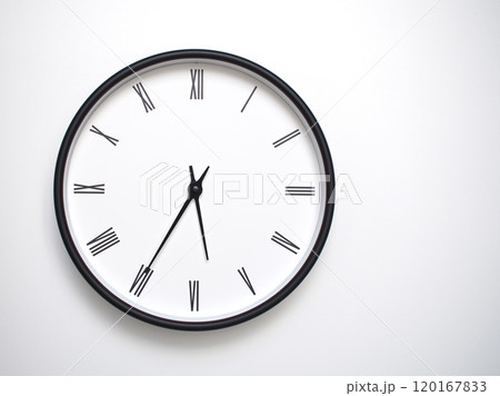 Clock Showing 17.35 or 05.35 with Roman Numerals. Simple Round Clock for Concepts of Time Management and Scheduling. 120167833