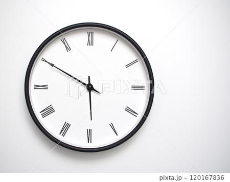 Clock Showing 17.50 or 05.50 with Roman Numerals. Simple Round Clock for Concepts of Time Management and Scheduling. Clock Showing 17.50 or 05.50 with Roman Numerals. Simple Round Clock for Concepts of Time Management and Scheduling. 120167836