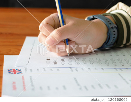 hand holding pencil over bubble answer sheet hand holding pencil over bubble answer sheet 120168063
