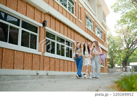 Three young women walking down a brick sidewalk Three young women walking down a brick sidewalk 120169952