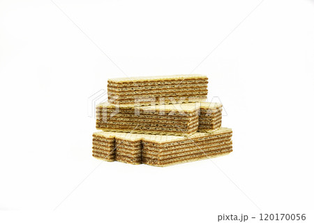 On a light background there are several strips of waffle dessert with chocolate filling On a light background there are several strips of waffle dessert with chocolate filling 120170056
