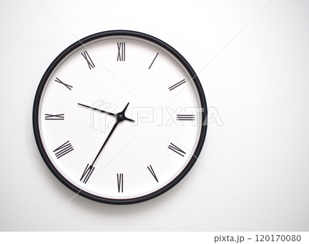Clock Showing 21.35 or 09.35 with Roman Numerals. Simple Round Clock for Concepts of Time Management and Scheduling. Clock Showing 21.35 or 09.35 with Roman Numerals. Simple Round Clock for Concepts of Time Management and Scheduling. 120170080