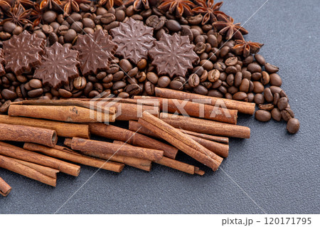 Food background. Coffee beans, cinnamon sticks, anise stars and chocolate candies. 120171795