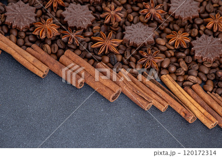 Food background. Coffee beans, cinnamon sticks, anise stars and chocolate candies. Food background. Coffee beans, cinnamon sticks, anise stars and chocolate candies. 120172314