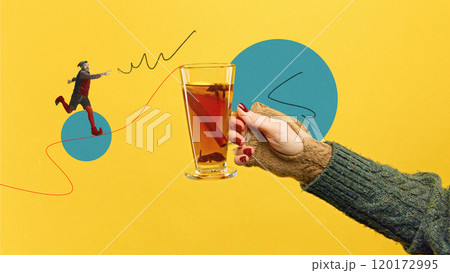 Glass of holiday tea with citrus, and cinnamon with little male elf running towards warm drink on brought yellow background. Contemporary art collage. 120172995