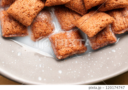 Chocolate cereal corn squares in rice milk, highlighting a mix of soft and crunchy textures, ideal for a delicious breakfast. Top view 120174747