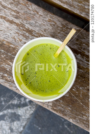 Eco-friendly organic matcha latte in a recyclable paper to-go cup. Bright green drink reflecting health and waste reduction for a sustainable lifestyle Eco-friendly organic matcha latte in a recyclable paper to-go cup. Bright green drink reflecting health and waste reduction for a sustainable lifestyle 120174780