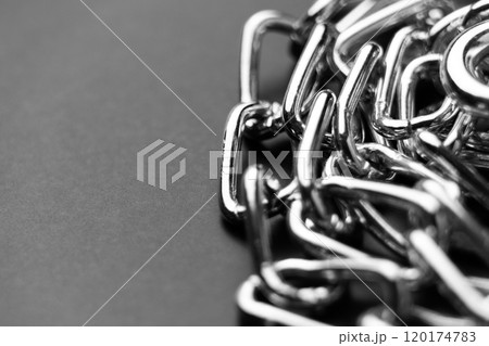 Stacked metal chrome chain with shiny connected links on black. Macro shot Stacked metal chrome chain with shiny connected links on black. Macro shot 120174783