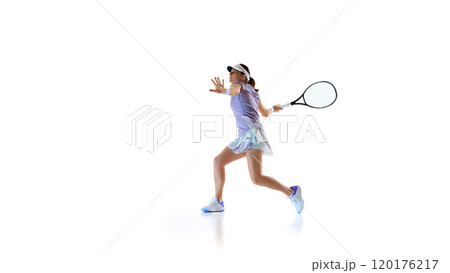 Ready and focused, athletic tennis player, exudes confidence and readiness during game against white studio background. Ready and focused, athletic tennis player, exudes confidence and readiness during game against white studio background. 120176217
