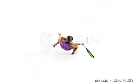 Overhead perspective of tennis player, eyes locked on ball, ready to deliver powerful serve against white studio background. 120176322