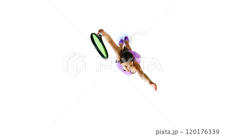 With intense gaze and extended arm, this tennis player embodies focus and readiness, prepared to deliver powerful shot against white studio background. 120176339