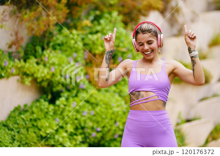 A Fitness Enthusiast Dancing Joyfully in Beautiful Nature Surrounded by Good Vibes 120176372