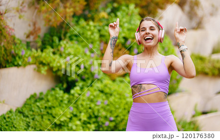 An Energized Woman Joyfully Dancing Outdoors While Wearing Stylish Athletic Wear An Energized Woman Joyfully Dancing Outdoors While Wearing Stylish Athletic Wear 120176380