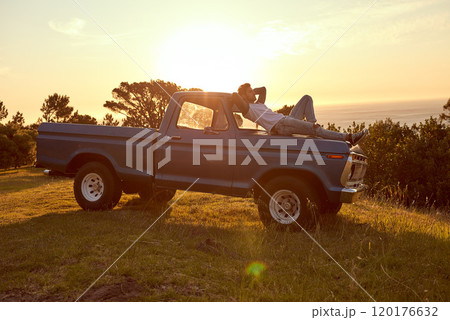 Do what your heart desires. Shot of a young man lying on the roof of his truck on a roadtrip. Do what your heart desires. Shot of a young man lying on the roof of his truck on a roadtrip. 120176632