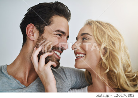 The tender loving touch of a partner is priceless. Shot of a young couple enjoying a relaxing and romantic moment at home. 120176802