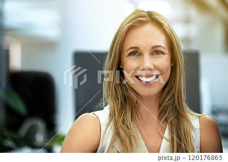 Working with a smile. Cropped portrait of a businesswoman sitting in her office. 120176863