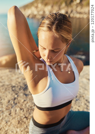 Yoga is so calm yet so energizing. Shot of a young woman doing yoga at the beach. Yoga is so calm yet so energizing. Shot of a young woman doing yoga at the beach. 120177024