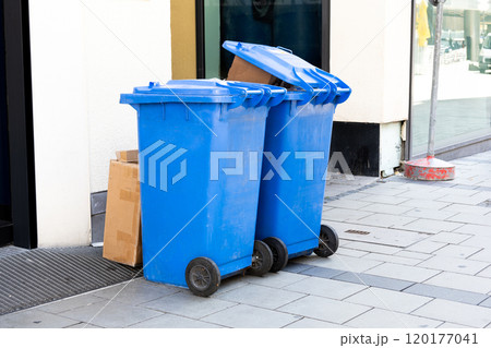 blue trash can at a side walk in munich 120177041