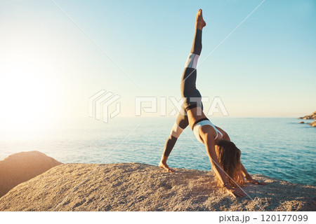 Do yoga a get in the best shape. Shot of an athletic young woman practicing yoga on the beach. 120177099