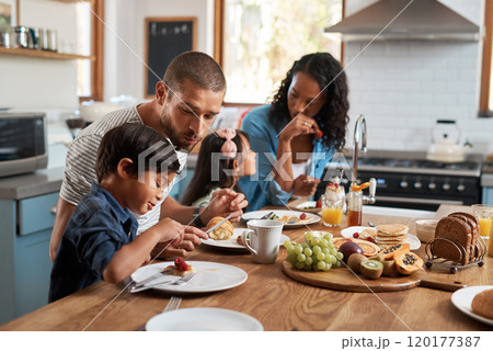 Its not a good morning without breakfast. Shot of a family of four enjoying breakfast together at home. 120177387