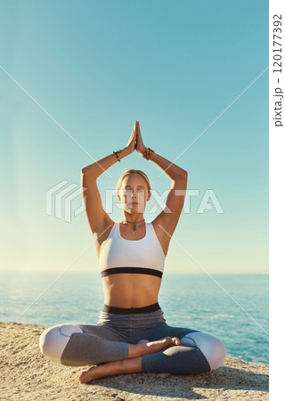 Living life on the yoga side. Shot of a young woman doing yoga at the beach. Living life on the yoga side. Shot of a young woman doing yoga at the beach. 120177392