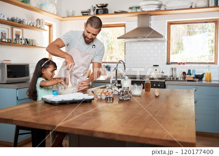 Lets get this batter ready to be scooped in. Cropped shot of a young man baking at home with his young daughter. Lets get this batter ready to be scooped in. Cropped shot of a young man baking at home with his young daughter. 120177400