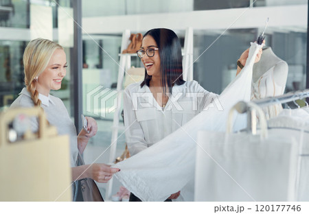This one is my best-seller. Shot of a sales assistant helping a young woman in a clothing boutique. 120177746