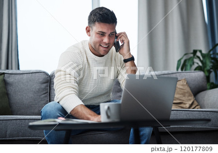 Hire yourself and make it happen. Shot of a young man using a laptop and smartphone while working from home. Hire yourself and make it happen. Shot of a young man using a laptop and smartphone while working from home. 120177809