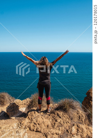 Girl standing on the edge of a cliff with...の写真素材 [120178015] - PIXTA