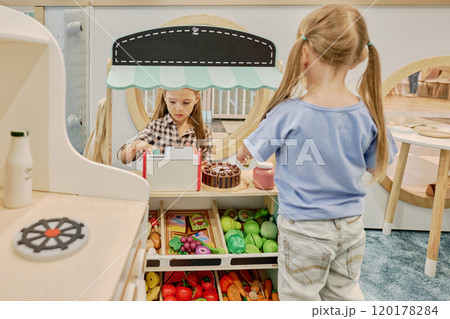 Cute little clerk serving buyer 120178284