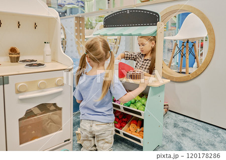 Serving little girl by market stand 120178286