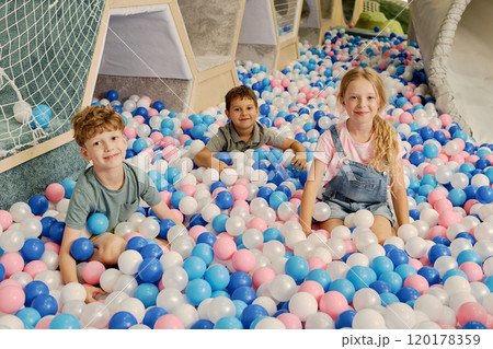 Adorable boys and girl with balloons 120178359