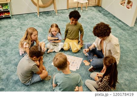 Teacher talking to little girl at lesson Teacher talking to little girl at lesson 120178419