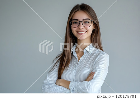 Smiling woman in glasses with arms crossed, confident posture 120178701