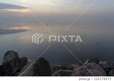 Foggy golden sunset over Lake Seksty. Landscape of Masuria in Poland, Karwik village in the Pisz area. 120178971