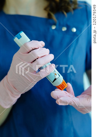 Doctor is demonstrating auto-injector syringe as an emergency treatment for allergic reaction Doctor is demonstrating auto-injector syringe as an emergency treatment for allergic reaction 120179349