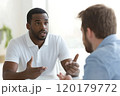 Man actively explaining his thoughts during a meeting with a colleague 120179772