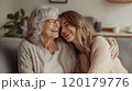Elderly woman and young woman embracing, smiling warmly 120179776