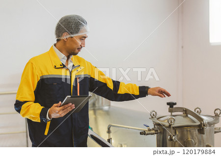 Winemaker working in modern large winery factory liquor drink industry quality. Staff inspecting wine in modern wine factory. Winery manufacturing quality control. Alcohol and wine winemaking process 120179884