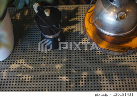 Coffee maker or moka pot on table in the kitchen.  120181431