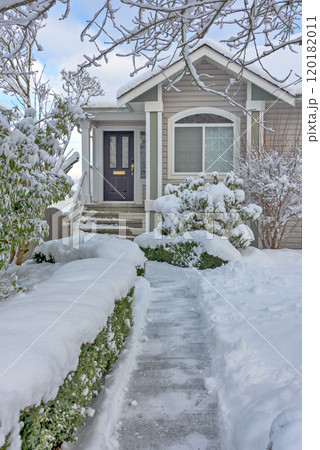 Cleaned pathway to the family residential house over front yard in snow Cleaned pathway to the family residential house over front yard in snow 120182011