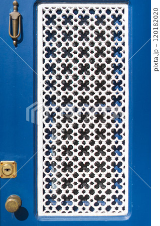 detail of blue door with white floral lattice 120182020