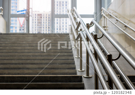 A beautifully designed set of stairs featuring a stainless steel railing 120182348