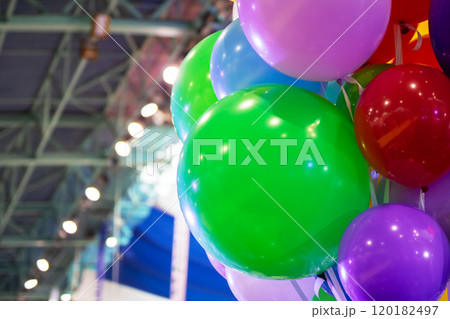 A large bunch of colorful balloons is beautifully hanging from the ceiling A large bunch of colorful balloons is beautifully hanging from the ceiling 120182497