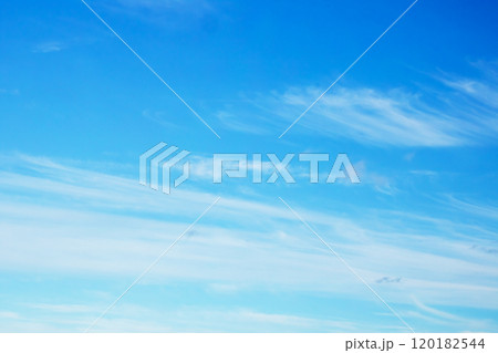 A vast blue sky adorned with fluffy white clouds spread across it A vast blue sky adorned with fluffy white clouds spread across it 120182544