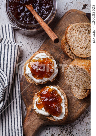 Onion jam on toast with cream cheese, gray background. 120182628
