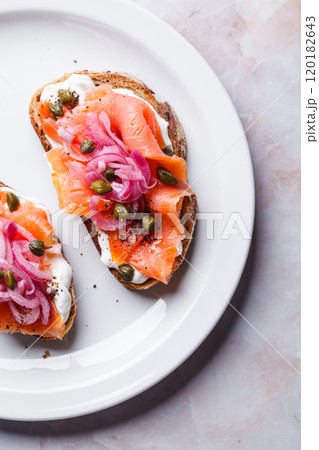 Salmon toast with cream cheese, pickled red onion and capers. Salmon toast with cream cheese, pickled red onion and capers. 120182643