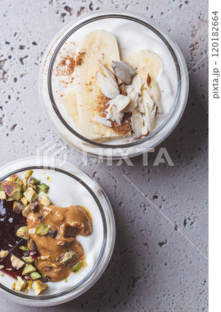 Overnight oatmeal with peanut butter, banana, nuts and jam in jars. Overnight oatmeal with peanut butter, banana, nuts and jam in jars. 120182664