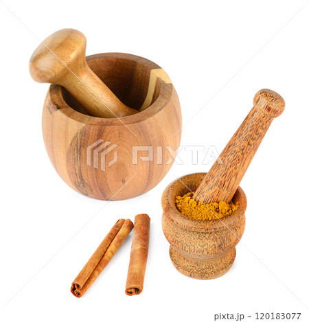 Wooden mortar, pestle, cinnamon sticks and powder isolated on white background. 120183077